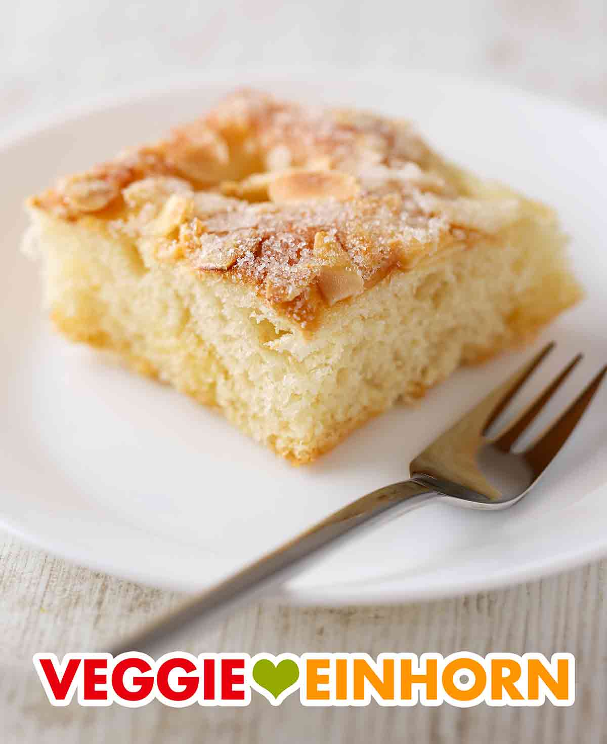 Ein Stück veganer Butter-Zuckerkuchen auf einem Kuchenteller