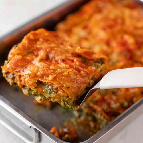Auflaufform mit veganer Gemüselasagne mit Spinat, Pilzen und Möhren