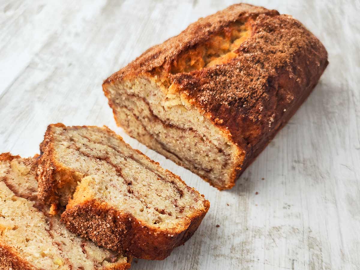 Veganes Bananenbrot mit Zimt, angeschnitten und mit Zimtzucker überzogen.